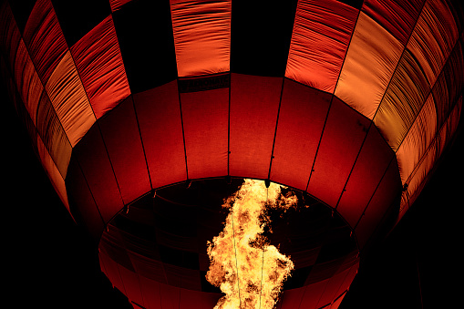 Close up of hot air balloon burner flame glowing at night