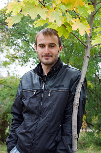 istock Young man standing near the autumn tree 93252274