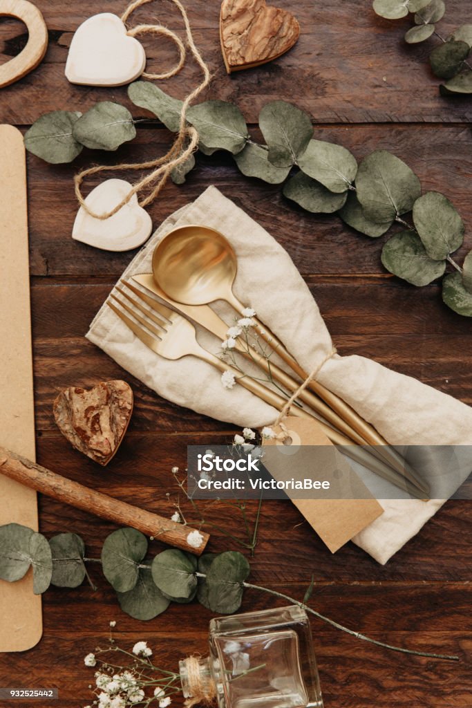 Gold cutlery. Festive table set with rustic decor. Flat lay Anniversary Stock Photo