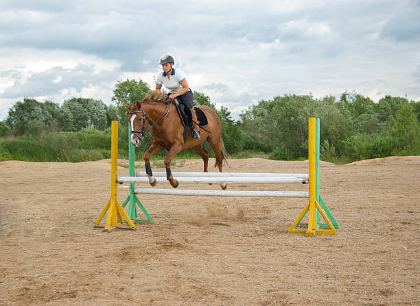istock girl riding horse and jumping 93252597