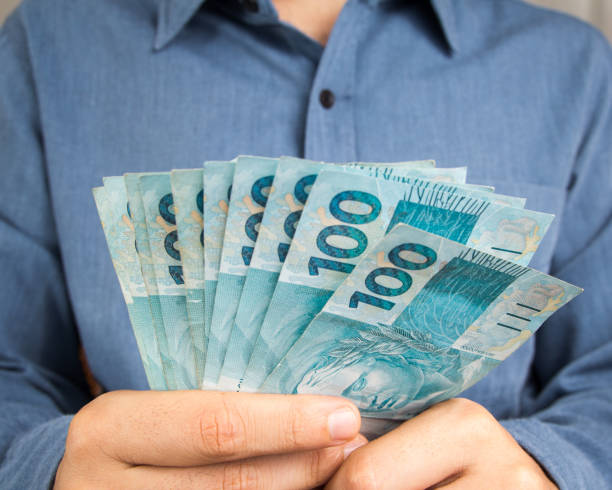 istock Midsection Of Man Holding Money 932533232