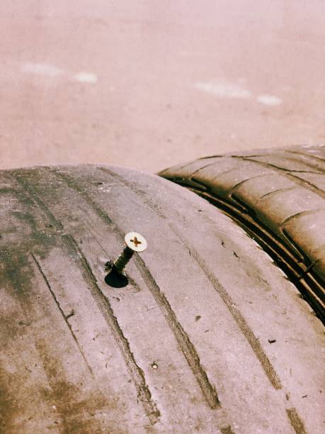 istock Nail on the tire. 932533918