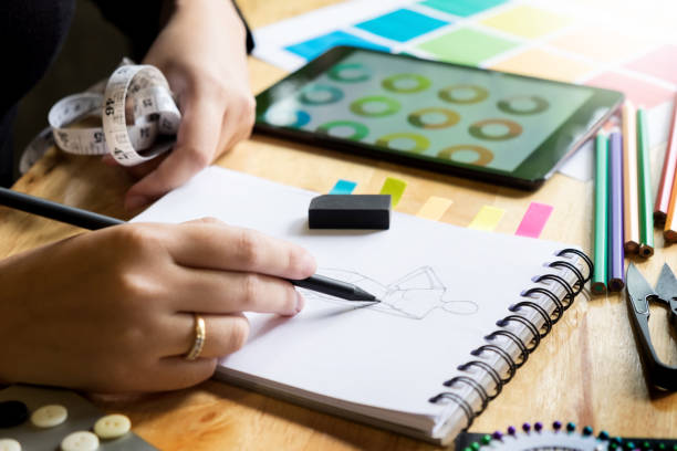 istock Cropped Hands Of Woman Drawing Sketch On Book At Workshop 932534270