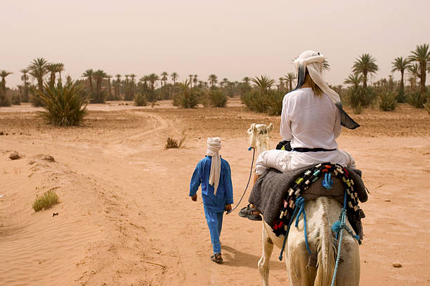 istock caravan of tourists in desert 93254114