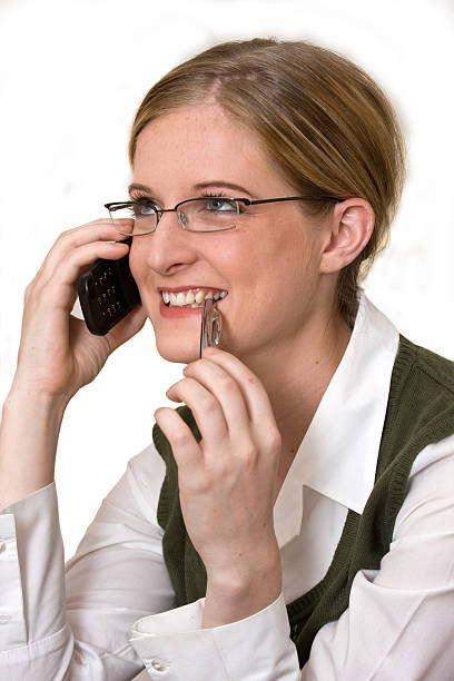 Young business woman with cell phone and pen stock photo
