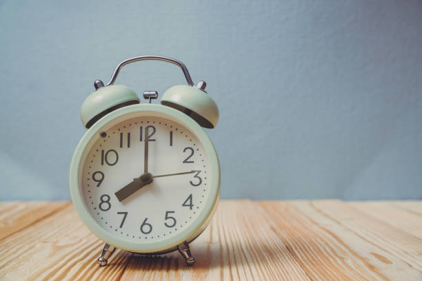 istock Retro vintage alarm clock on wood table, time concept. 932542490