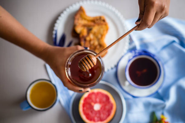 Croissant and fruits with honey over the table