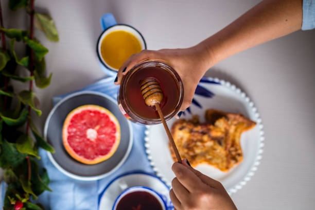 Croissant and fruits with honey over the table