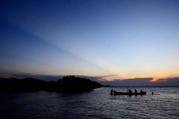 Silhouetted Canoe in Mozambique stock photo