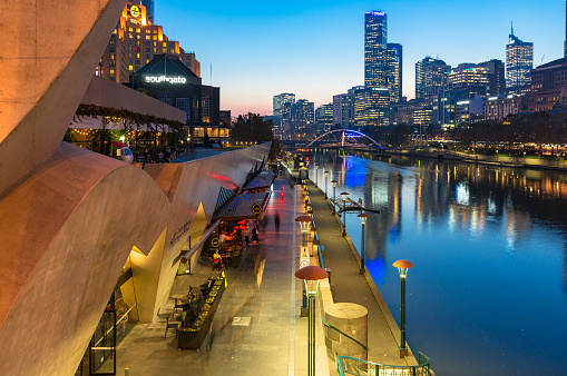 Melbourne, Australia - April 18, 2017: Melbourne Southbank Promenade with restaurants and CBD view at dusk