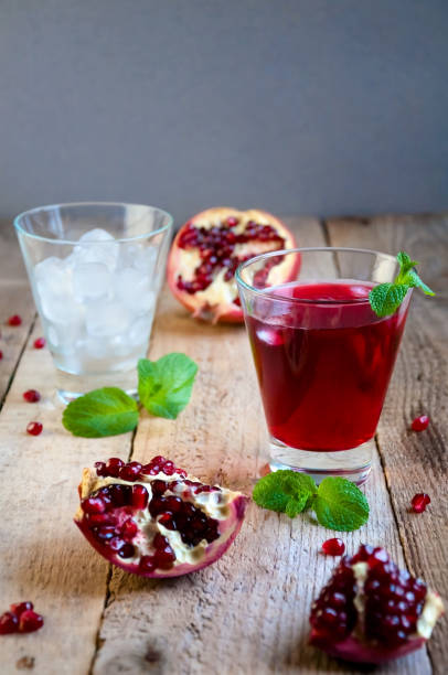 istock Pomegranate Cocktail with Ice Mint and Fruit on Wooden Table. Refreshing Summer Drink Soft or Alcoholic 932552388