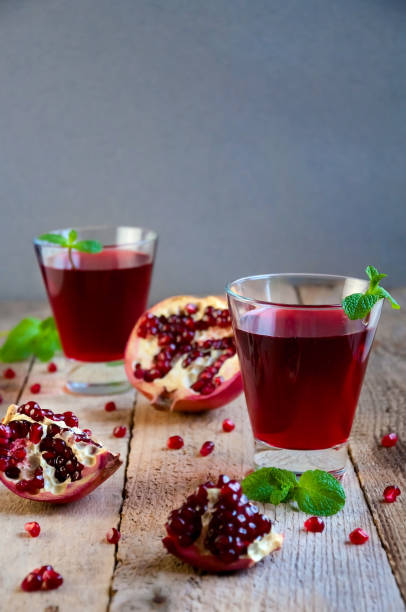 istock Pomegranate Cocktail with Mint and Fruit on Wooden Table. Refreshing Summer Drink Soft or Alcoholic 932552392