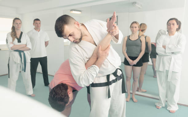 istock man training new taekwondo holds with adults during class 932552566