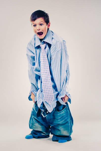 istock funny boy wearing Dad's clothes 932553154