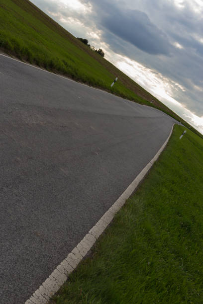 istock cloudy sky with road and horizon 45 degree twisted 932553230