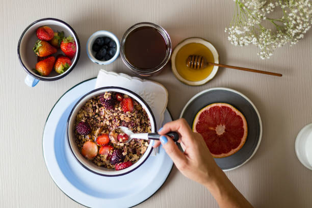 istock Healthy breakfast: whole grain cereal with some fruits over the table 932555434