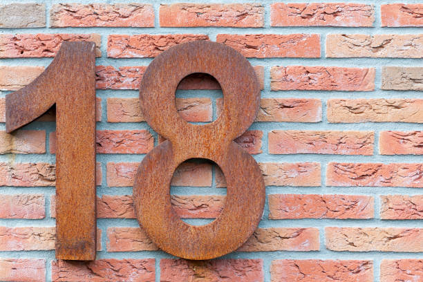 Number eighteen in red on a brick wall