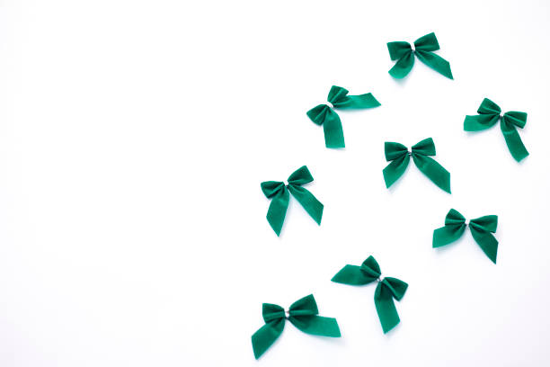 istock Green velvet bows on white background 932560356