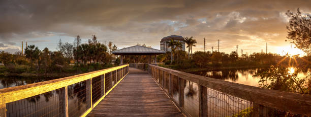 istock Sunset over Gazebo on a wooden secluded, tranquil boardwalk 932565370