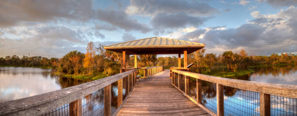istock Sunset over Gazebo on a wooden secluded, tranquil boardwalk 932565372