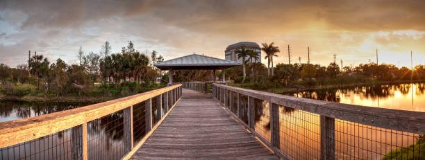 istock Sunset over Gazebo on a wooden secluded, tranquil boardwalk 932565376