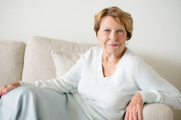 istock Happy Senior Woman in sofa 932577100