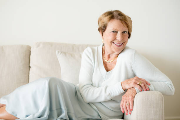istock Happy Senior Woman in sofa 932577116