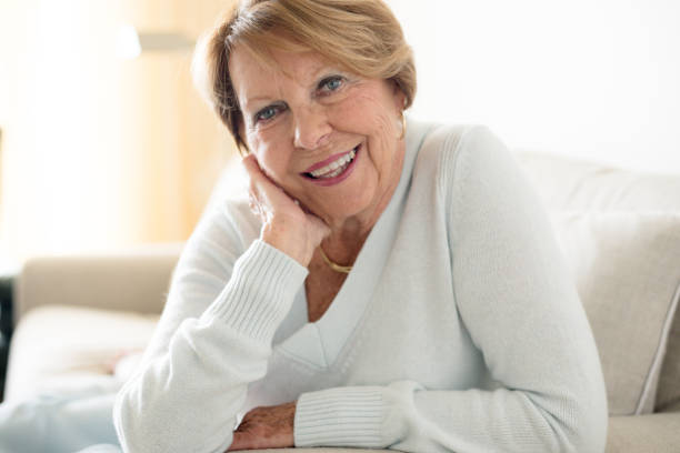 istock Happy Senior Woman in sofa 932577138