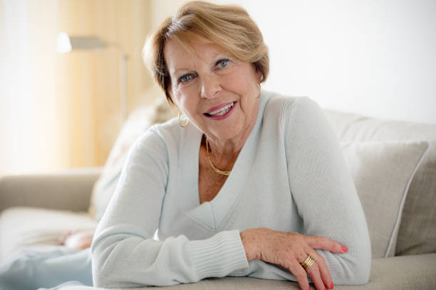 istock Happy Senior Woman in sofa 932577152