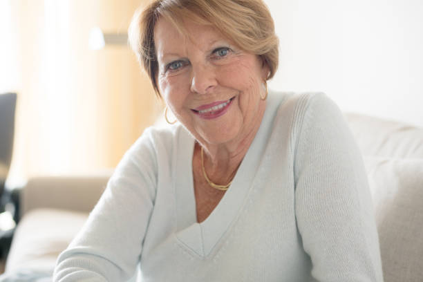 istock Happy Senior Woman in sofa 932577172