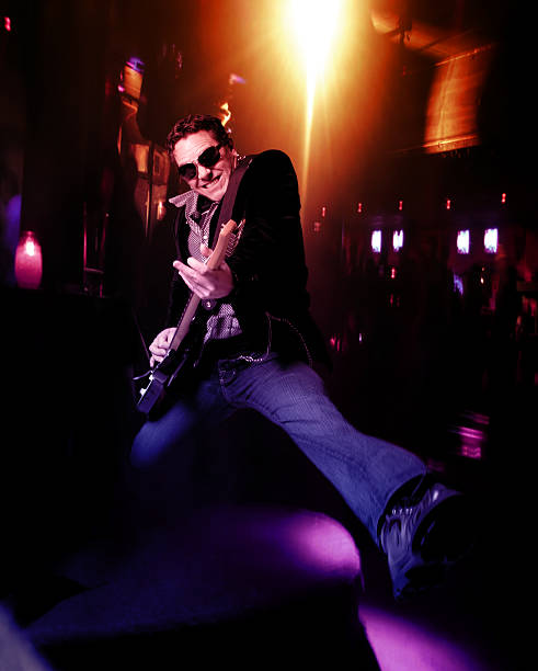 Guy playing the guitar demonstrating rock n roll