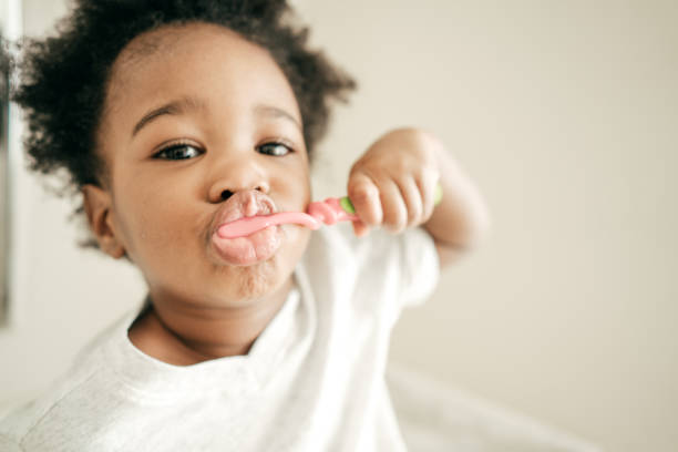 istock Baby girl brushing teeth 932585936