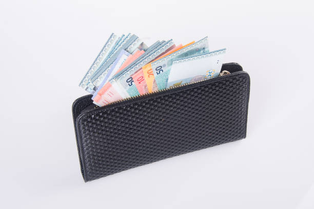 istock woman wallet with money on background. 932587528