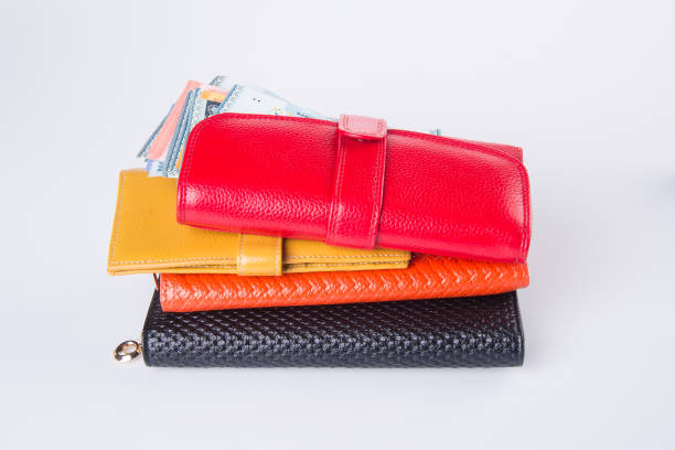 istock woman wallet with money on background. 932587532