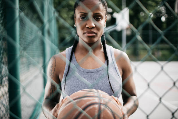 istock Woman playing basketball 932593148