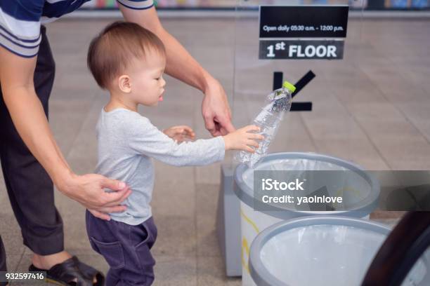 Asian Father Teach Cute Little 18 Months 1 Year Old Toddler Baby Boy Child Throwing Plastic Bottle In Recycling Trash Bin At Public Place Stock Photo - Download Image Now