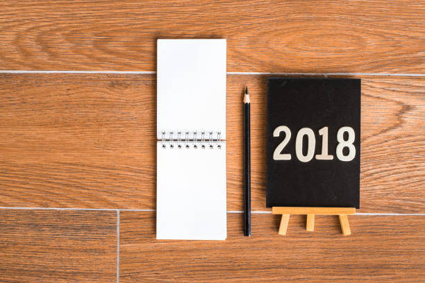 istock notepad, blackboard with pencil on wood board background.using wallpaper for education, business photo.Take note of the product for book with paper and concept, object or copy space. 932600984