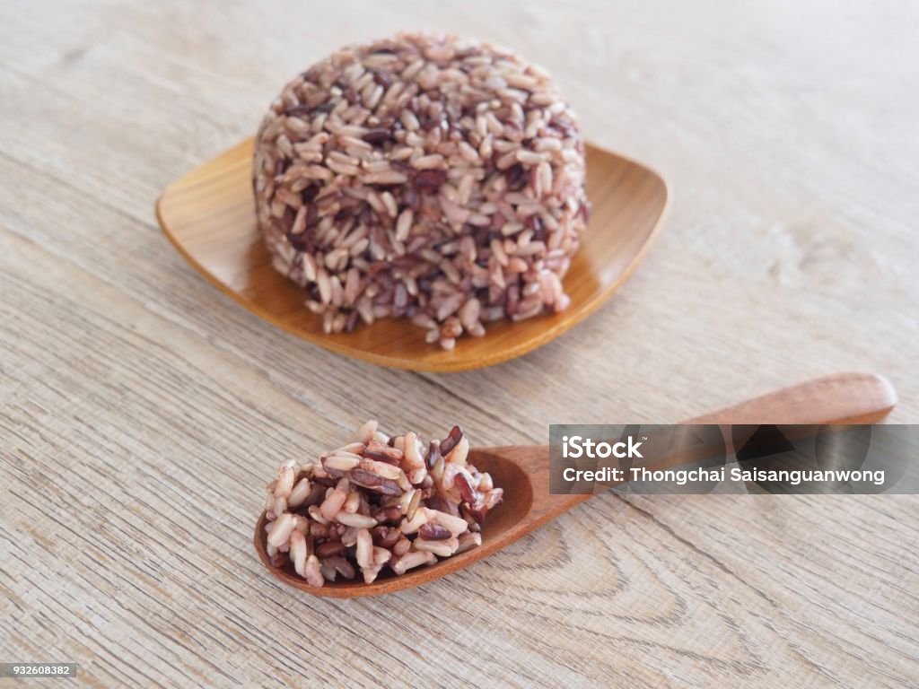 Thai Steam Rice Berry in a wooden dish and spoon on an old wooden table in a healthy diet. And the benefits of nutrition. Strengthens the body and shape. Brown Stock Photo