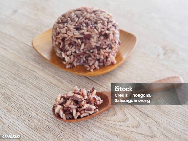 Thai Steam Rice Berry In A Wooden Dish And Spoon On An Old Wooden Table In A Healthy Diet And The Benefits Of Nutrition Strengthens The Body And Shape Stock Photo - Download Image Now