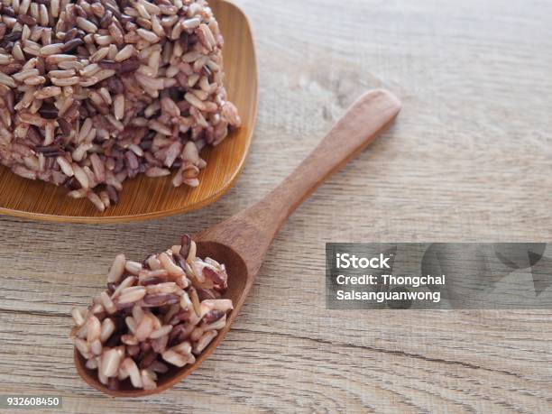 Thai Steam Rice Berry In A Wooden Dish And Spoon On An Old Wooden Table In A Healthy Diet And The Benefits Of Nutrition Strengthens The Body And Shape Stock Photo - Download Image Now