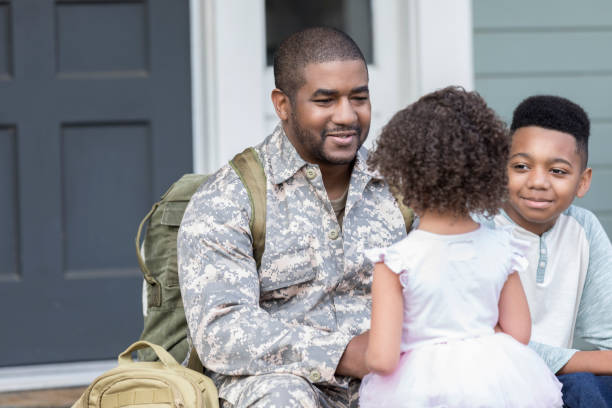 istock Caring dad talks with children before leaving for military assignment 932608582