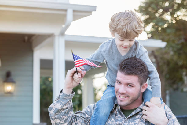 istock Military dad carries son on shoulders 932608584