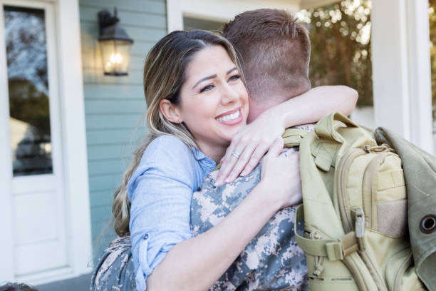 istock Relieved wife is happy to see her military husband 932608596