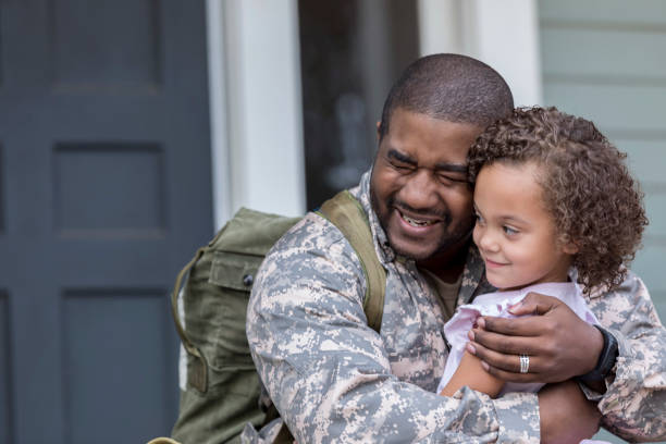 istock Man is upset to leave his young daughter for military assignment 932608598