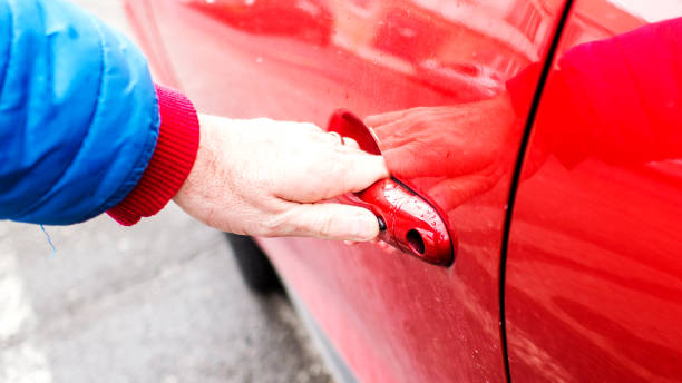 istock opening rear back red car's door 932612552
