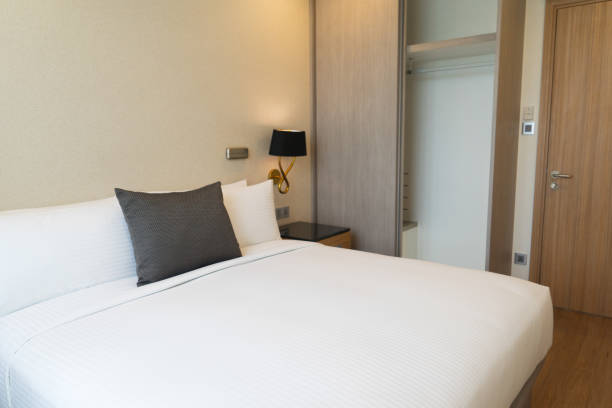 istock Bedroom suite with hanging lamp in hotel 932613120