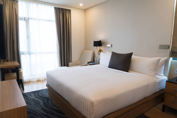 istock Small bedroom with curtains and modern furniture 932613224