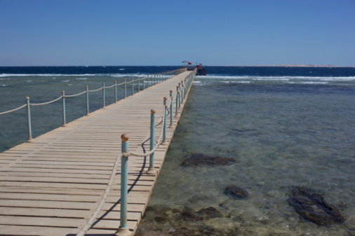 Playa de Muro with idyllic long wooden jetty in caribbean colored waters with seagulls