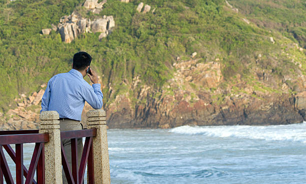 Man talking on cellphone outside stock photo