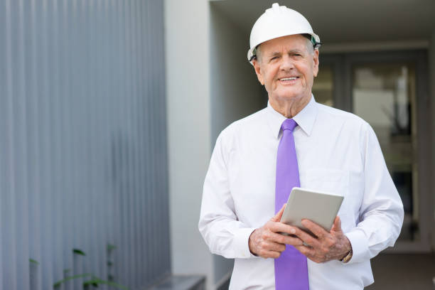 Smiling Chief Engineer with Tablet Reviewing Site